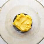 Wet dough in a glass mixing bowl.