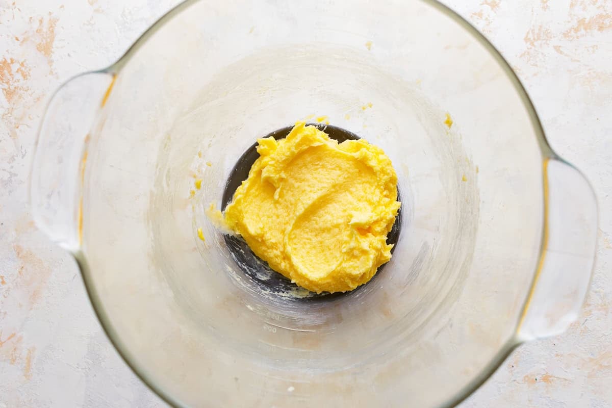 Wet ingredients for caramel snickerdoodles in a glass mixing bowl.