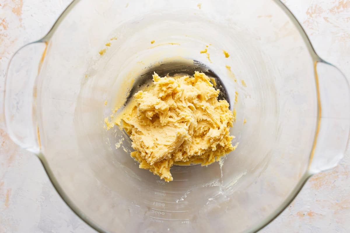 Caramel snickerdoodle dough in a glass mixing bowl.