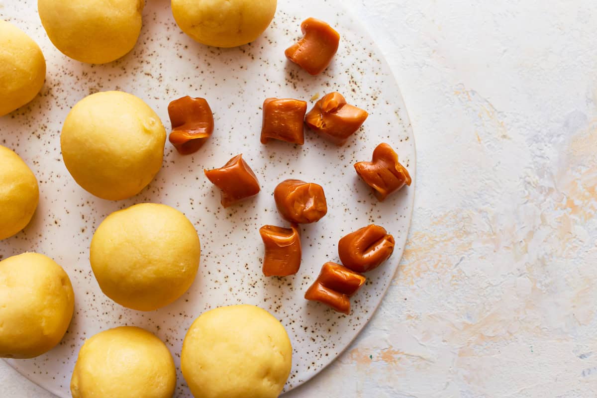 Rolled snickerdoodle dough and caramels.