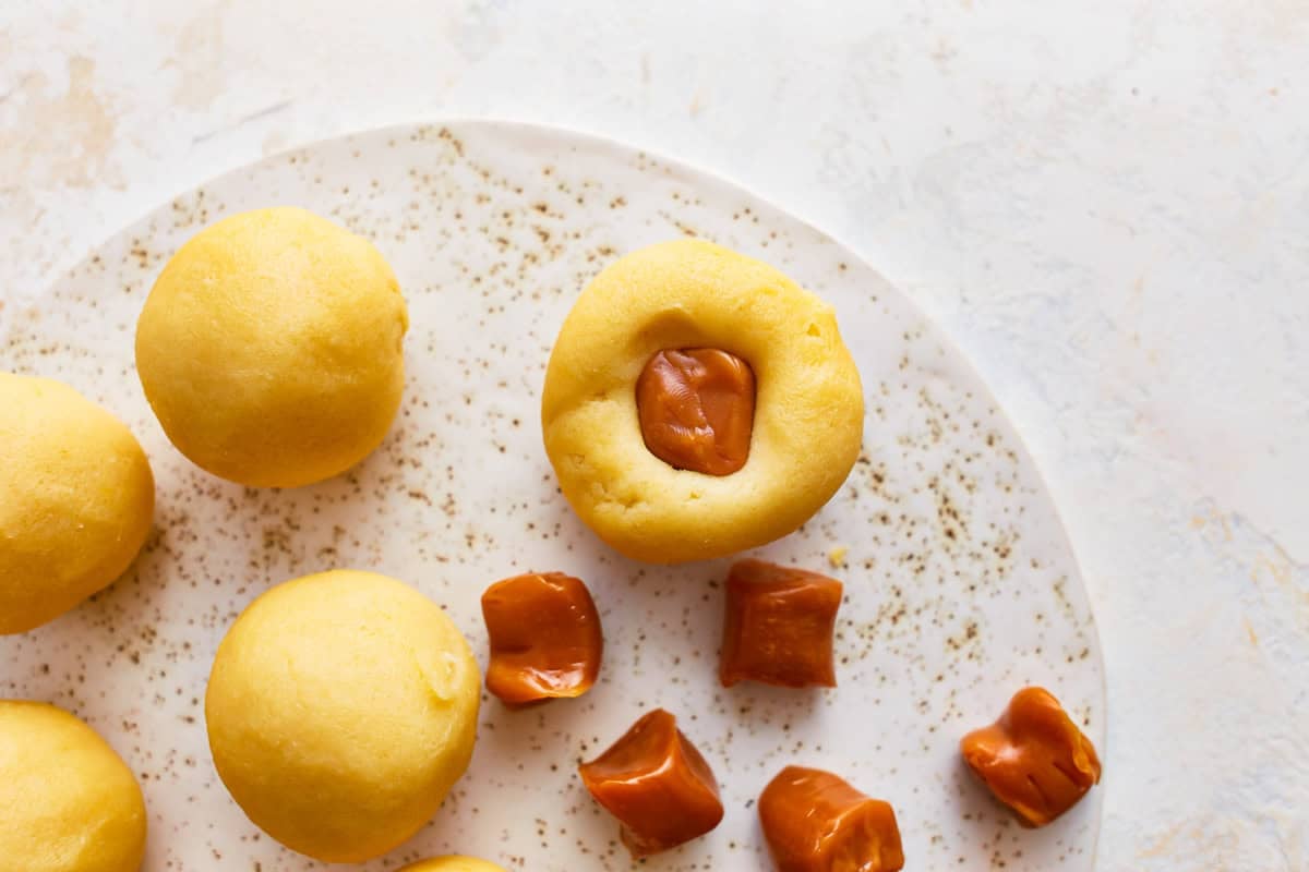 A caramel candy pushed into snickerdoodle dough.