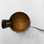 Checking the temperature of simmering caramel.
