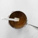 Stirring caramel in a saucepan.