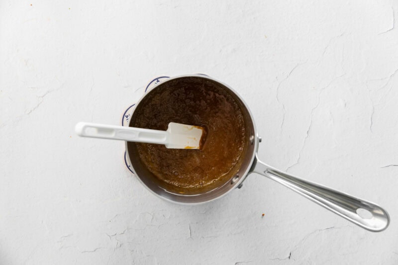 Stirring caramel in a saucepan.