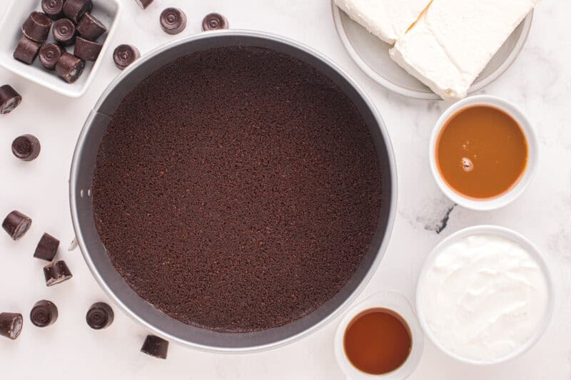 Chocolate cheesecake crust pressed into a springform pan.
