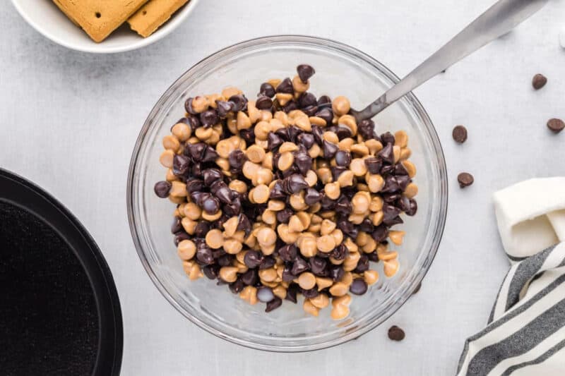 Chocolate chips and peanut butter chips combined in a small bowl.