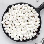 Mini marshmallows layered into a cast iron skillet.