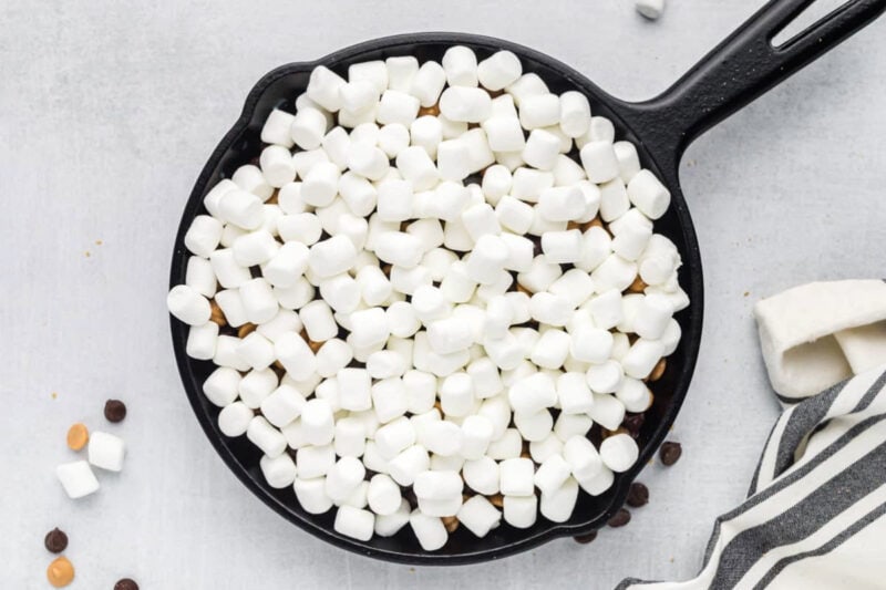 Mini marshmallows layered into a cast iron skillet.