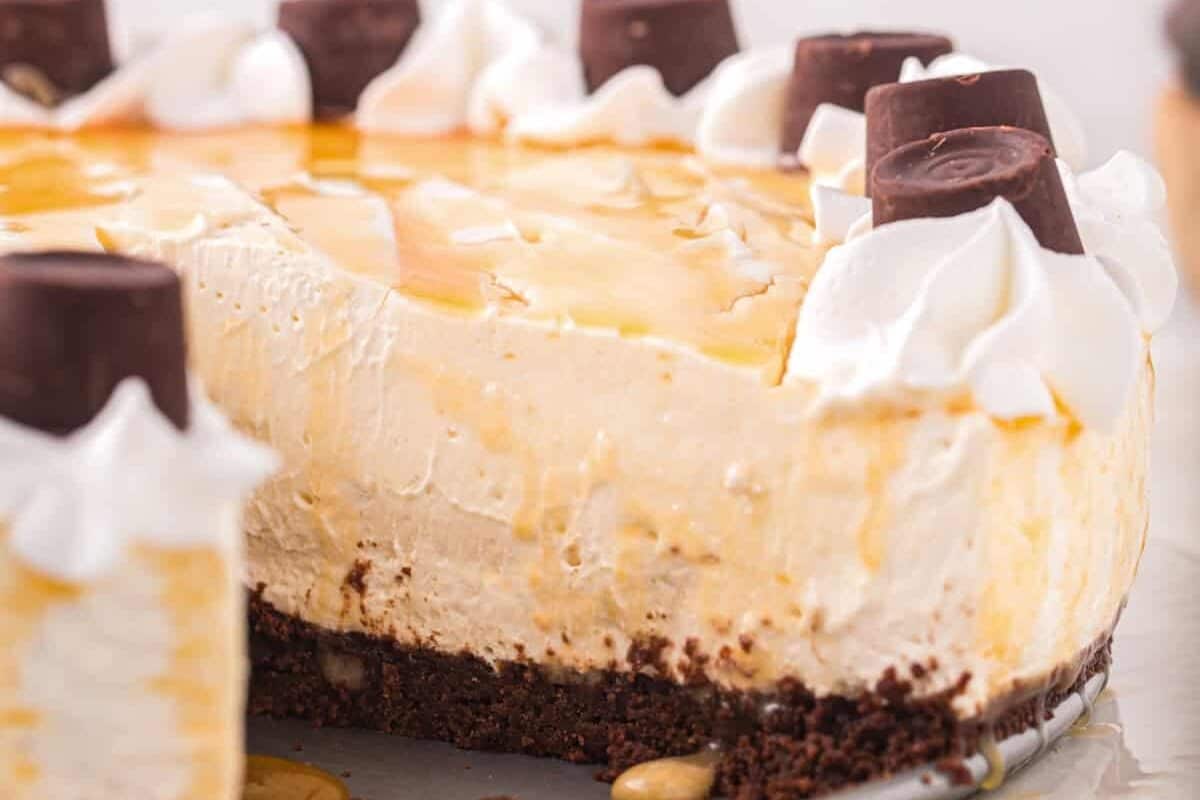 Side view of no bake rolo cheesecake, with a slice removed to show the layers.