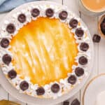 Completed Rolo cheesecake topped with whipped topping, caramel, and Rolo candies.
