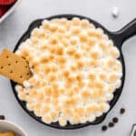 Cookie dipped into baked s'mores dip.