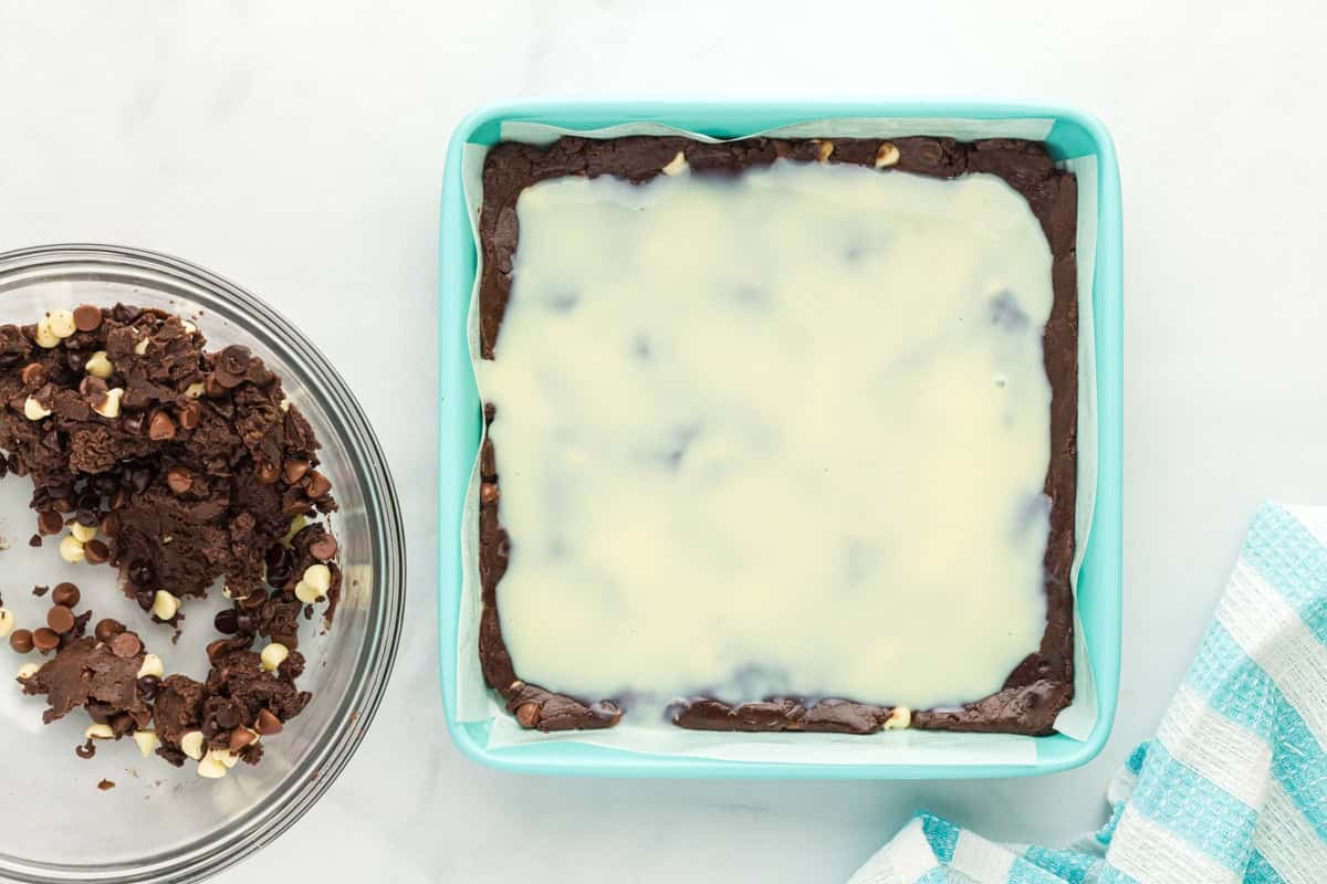 Sweetened condensed milk added on top of cake mix brownie batter.