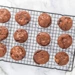 Baked Reese's chocolate cupcakes cooling on a wire rack.