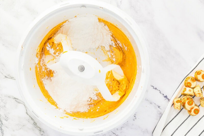 Mixing powdered sugar into frosting mixture.