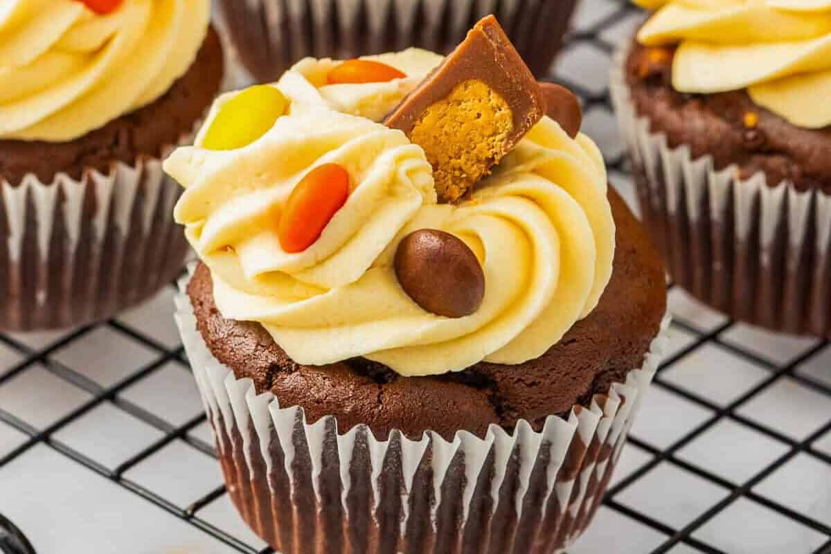 Reese's chocolate and peanut butter cupcakes, decorated with caramel frosting, Reese's Pieces, and Reese's Peanut Butter Cups.