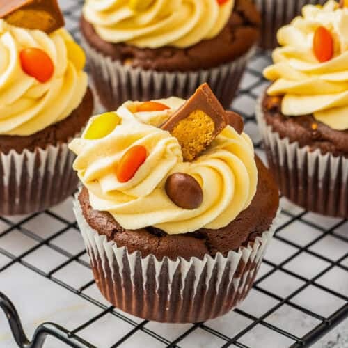 Reese's chocolate and peanut butter cupcakes, decorated with caramel frosting, Reese's Pieces, and Reese's Peanut Butter Cups.
