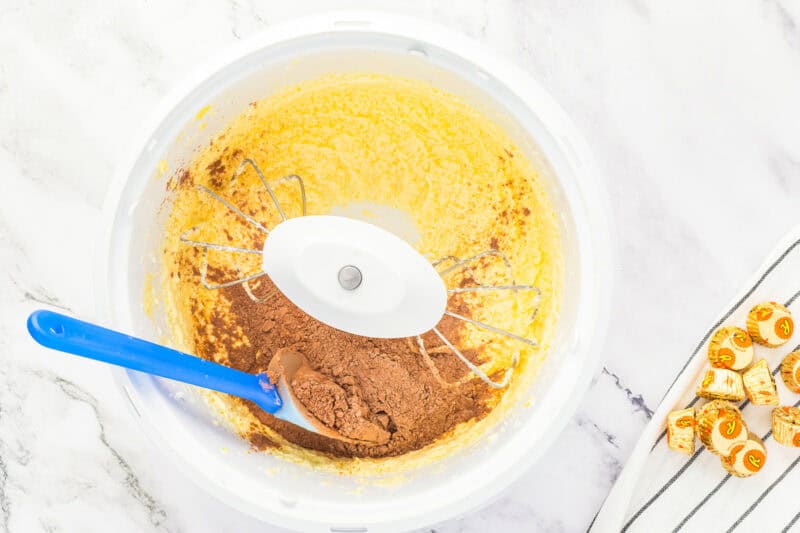 Mixing dry ingredients into wet ingredients.