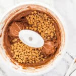 Mixing Reese's peanut butter chips into chocolate cupcake batter.