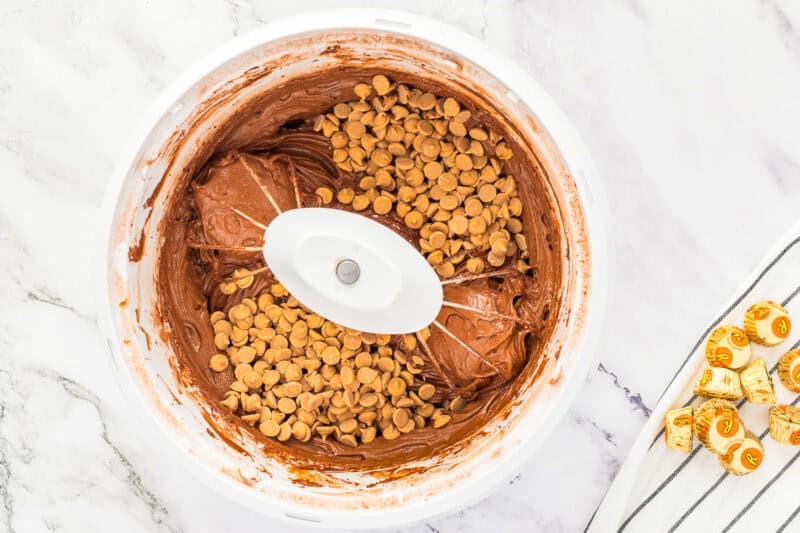 Mixing Reese's peanut butter chips into chocolate cupcake batter.